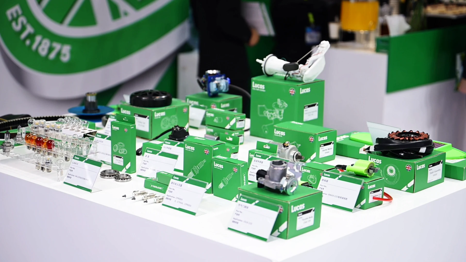 Lucas motorcycle components and green boxes on display